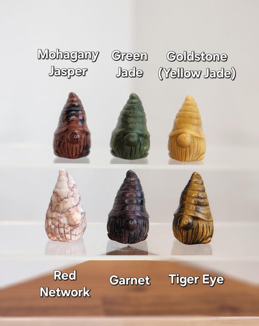 a collection of six unique gnome-shaped objects, each with a different color and pattern, arranged in a grid-like pattern.