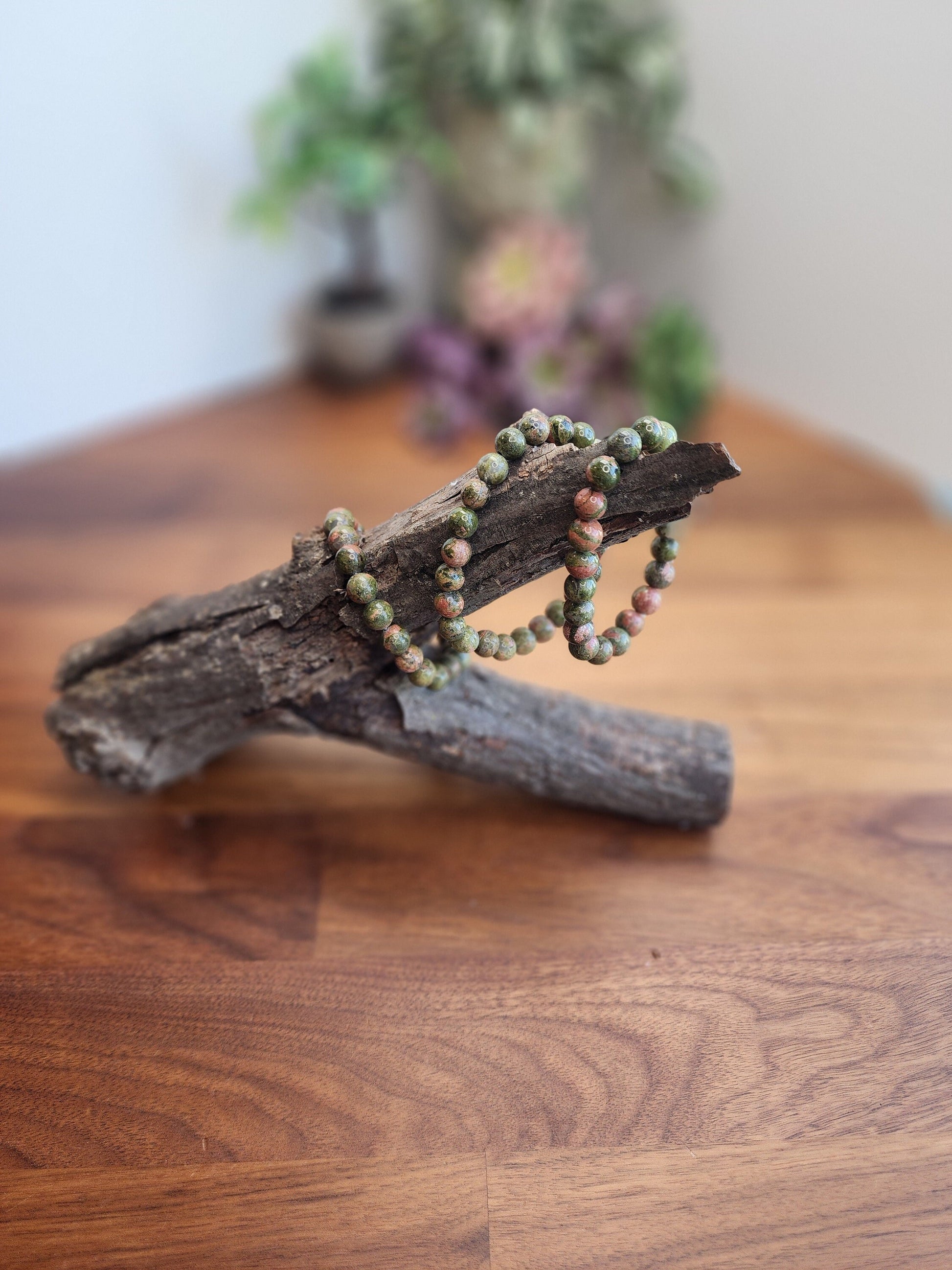 Unakite Crystal Bracelet. 8MM natural crystal beads on stretchy band. Gorgeous woodsy green and light orange reds make an interesting and complimentary pair.