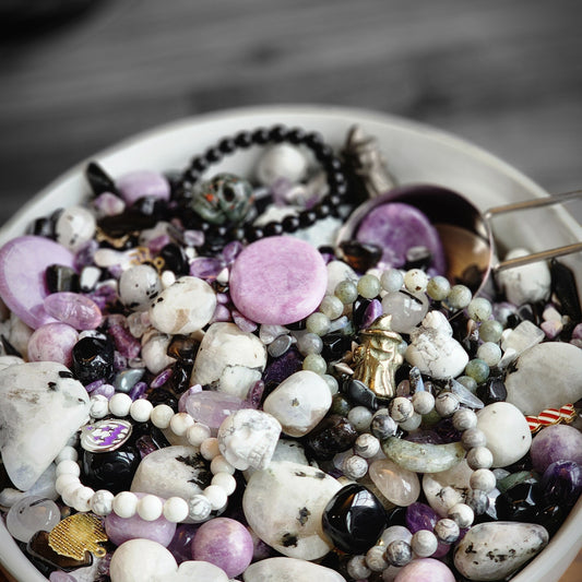 Spooky Crystal Confetti includes lots of Halloween and gothcore vibes with Black Obsidian, Purple Lepidolite, and pops of green like Zoisite and Malachite. Ghosts, Coffins, and Voodoo Dolls carvings are in the mix with Worry Stones, and Bracelets.