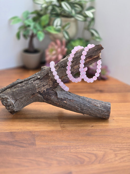 Pretty Pink Rose Quartz Crystal Bracelets. 8mm round crystal beads on a stretchy elastic band. Part of our Bracelet Favorites and bestsellers section!