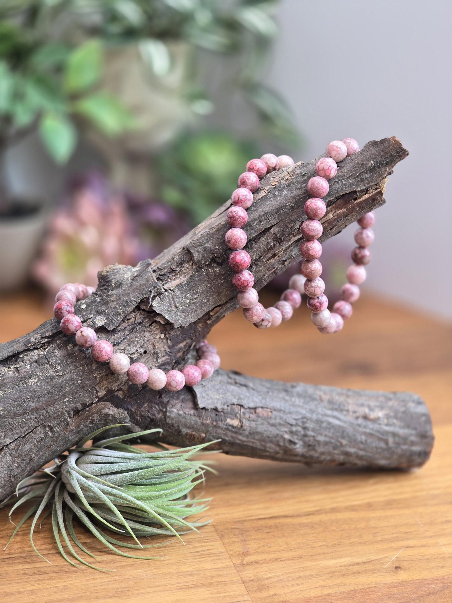 Pink Fossil Stone Bracelets in 8mm crystal beads on a stretchy elastic band to fit various wrist sizes. Gorgeous orbicular patterns in pink, red and cream.