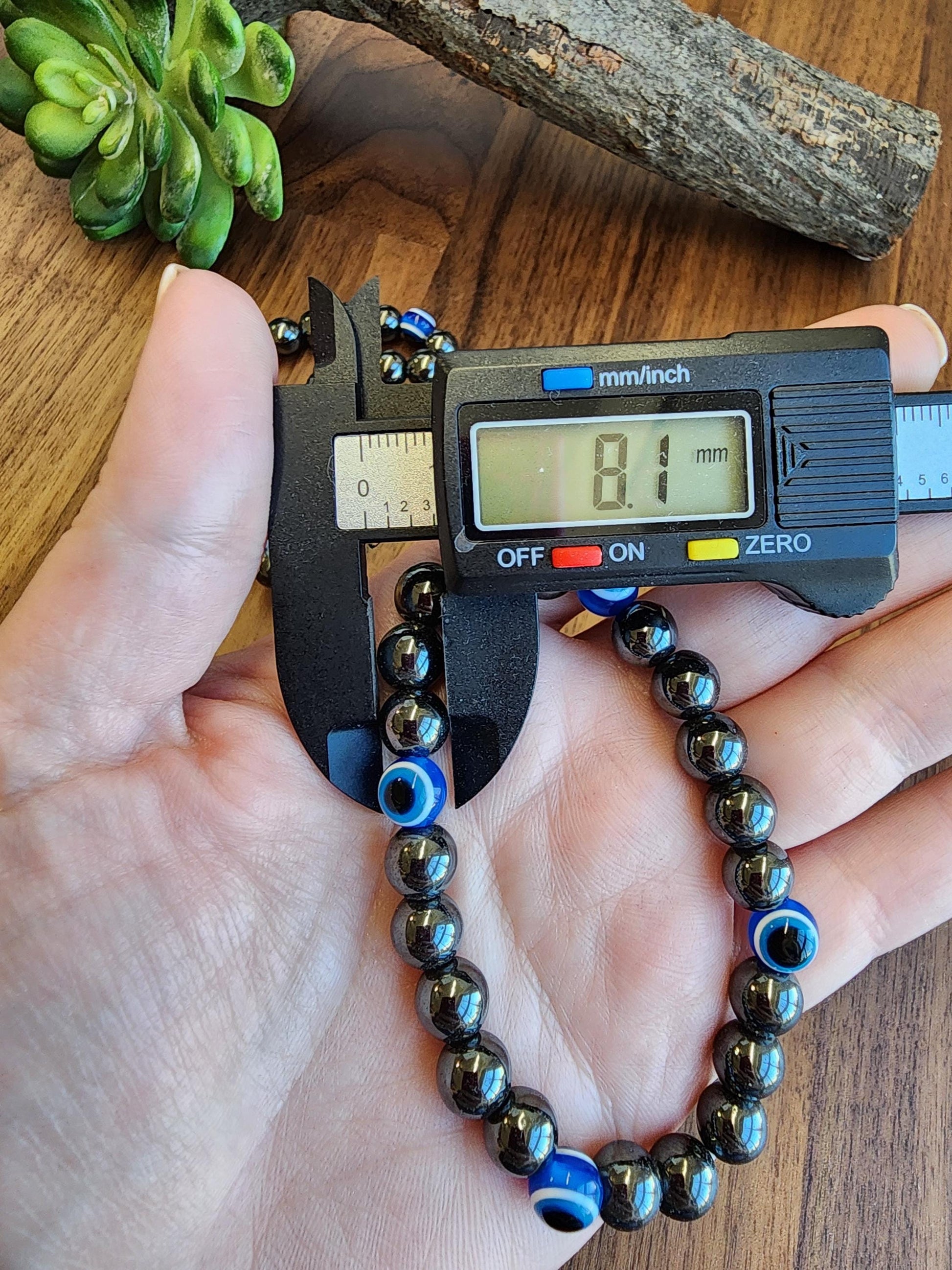 Evil Eye Hematite Bracelet: 8MM Tera Hertz Beads with Blue & Black Protection Charms