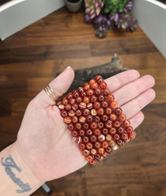 Gorgeous High Quality Sardonyx Carnelian Bracelets with 8mm crystal beads. Hand holding these bestsellers. Amazing Banded Red, white and Orange agate jewelry.