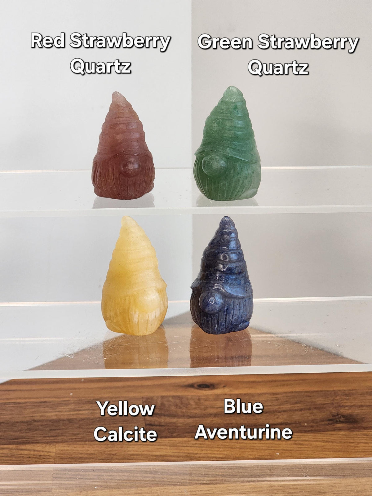 four colorful gnome figurines, each representing a different type of quartz: Red Strawberry, Green Strawberry, Yellow Calcite, and Blue Aventurine.