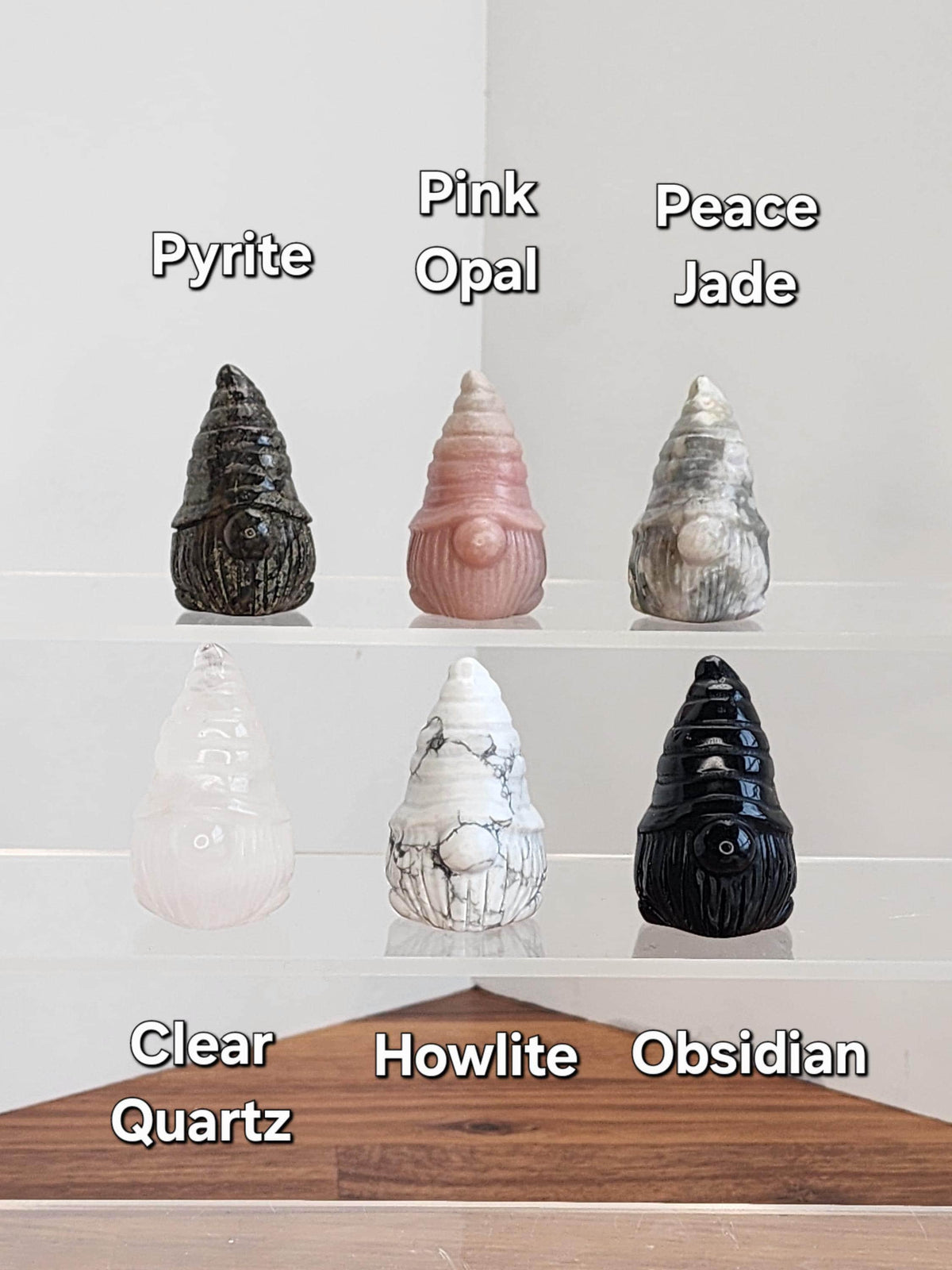 a collection of seven different types of gnome figurines, each with a unique color and texture, arranged on a shelf.