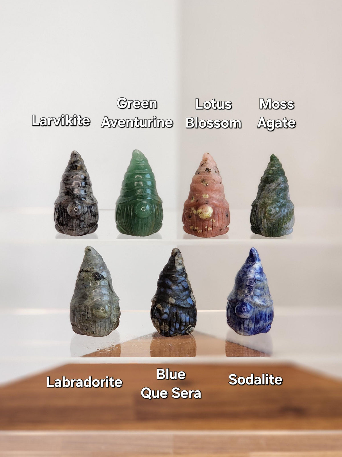 a collection of seven unique gemstones, each with its own distinct color and shape, arranged in a grid-like pattern.