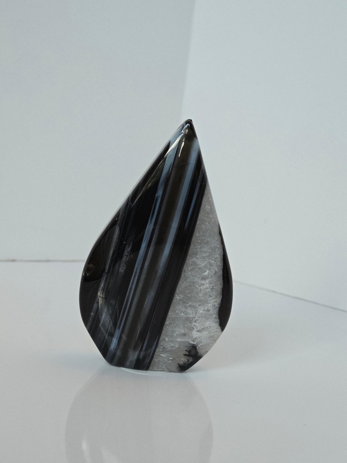 a black and white striped rock formation, which appears to be a piece of art or a decorative item.